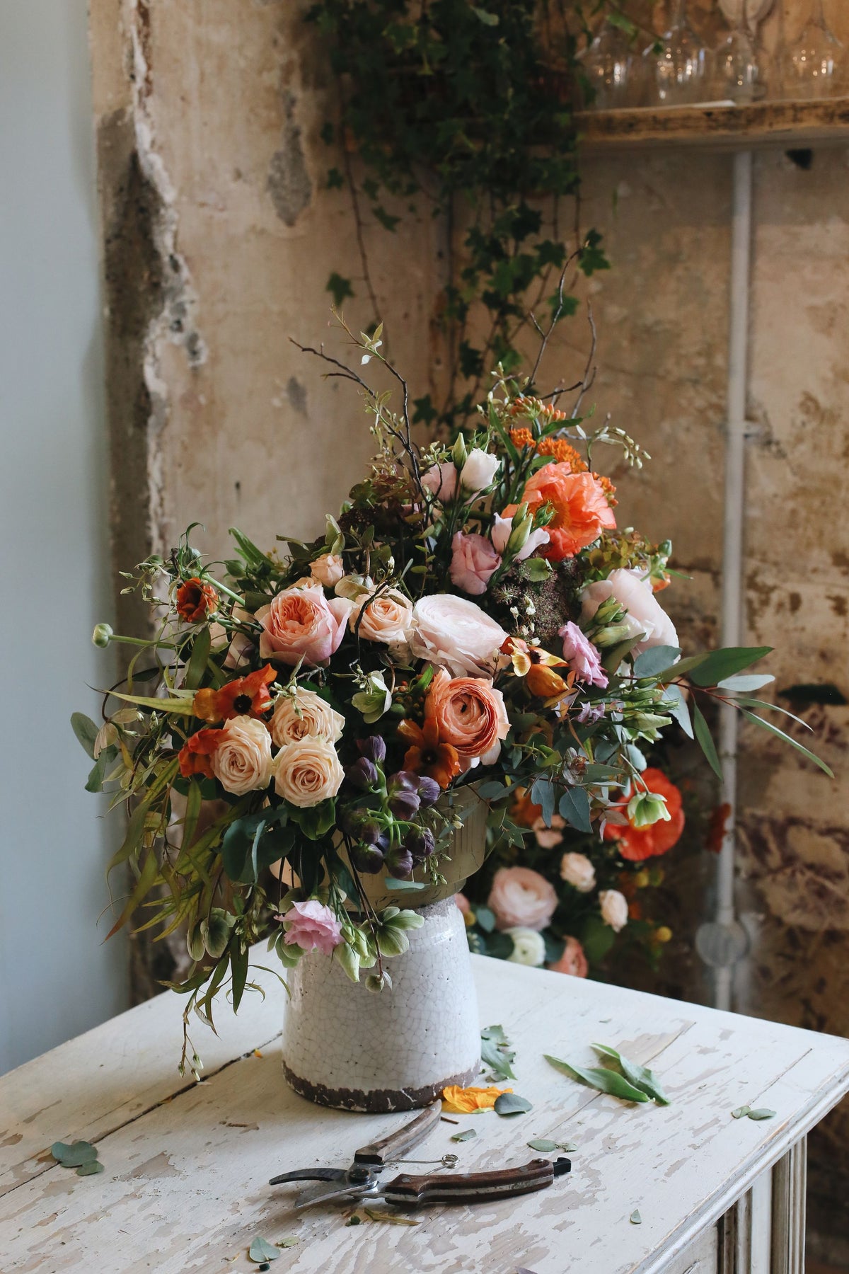 A large arrangement of peach roses and trailing greens